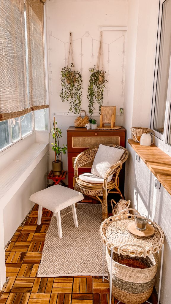 Warm and inviting boho-style balcony with rattan furniture and hanging plants.
